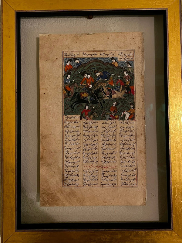 Framed ancient text with illustrations on a wall